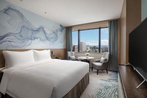 Postel nebo postele na pokoji v ubytování Foreign Trade Centre C&D Hotel,Fuzhou