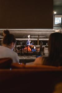 a group of people sitting in front of a fire place at Le Fitz Roy, a Beaumier hotel in Val Thorens