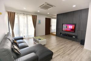 a living room with a couch and a flat screen tv at 75 pangkor ocean in Pangkor