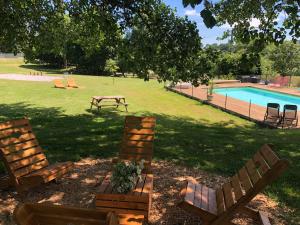two chairs and a table next to a swimming pool at Maison d'hôtes Ourdeaux et Gite Chez Rouchon in Aubusson +43 photos