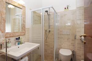 a bathroom with a shower and a sink and a toilet at Houspitality Caesar Bed & Breakfast in Rome +29 photos
