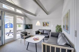a living room with a couch and a table at Lalandia Rødby in Rødby