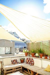 patio z białym baldachimem i roślinami w obiekcie Tamaran House w mieście Las Palmas de Gran Canaria