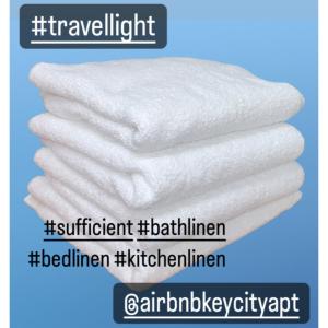 a stack of white towels on a blue background at KeyCity Apt Near Amsterdam & The Hague in Leiden