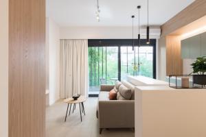 a kitchen and living room with a couch and a table at Voda Luxury Residence #101 in Athens