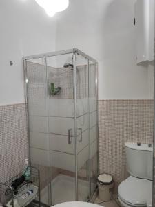 a glass shower in a bathroom with a toilet at Casa Desir&egrave; in Catania