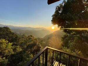 a view of the sun setting over the mountains at Glorious Nature Inn in Ella