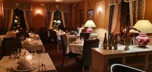 a dining room with tables and chairs and tablesktop at Wellness Hotel Zlatá Lípa in Děčín