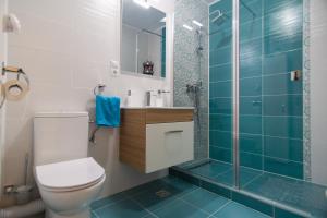 a bathroom with a toilet and a glass shower at Azure Home in Cluj-Napoca