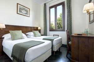 a hotel room with two beds and a window at Grand Hotel Gianicolo in Rome