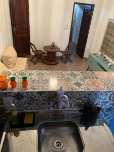 a kitchen with a sink and a counter top at Kitnet Arembepe - Aconchego da Lulu in Arembepe +28 photos