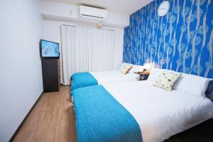 Postel nebo postele na pokoji v ubytování HOTEL AARON通天西