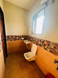 a bathroom with a toilet and a sink at iIRA Stays-Awas Beach Resort - Pet Friendly in Alibaug
