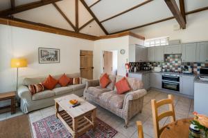 a living room with a couch and a table at The Garlic Farm in Sandown