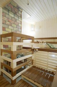 a kitchen with wooden shelves and a brick wall at Boutique Hotel Traditional in Astana