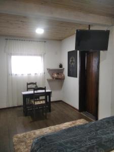 - une chambre avec un lit, une table et une fenêtre dans l'établissement Chalé Suite do chá, à Lavras Novas
