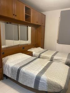a bedroom with two beds and a flat screen tv at Apartments Cal Benet in Camarasa