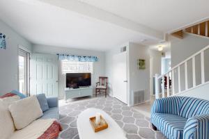 a living room with a couch and a tv at Dewey Villas --- 24 Dickinson Ave, Unit #8B in Dewey Beach