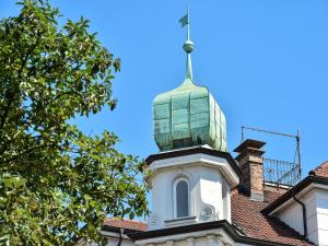a building with a green turret on top of it at The Cozy Lindau No 3 in Lindau