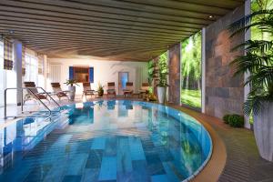 a swimming pool in a house with blue tiles at WILLINO Privathotel in Willingen