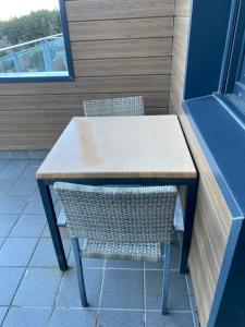 a table and a chair sitting next to a window at Hostal La Pinilla in Segovia