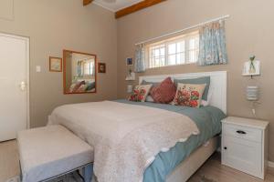 a bedroom with a large bed and a window at Tweni Cottage in Clovelly