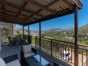 a balcony with a table and chairs and a view at Tweni Cottage in Clovelly
