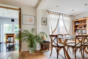 a dining room with a table and chairs at Orchard - 3 Bedroom House Headington & parking & garden in Oxford