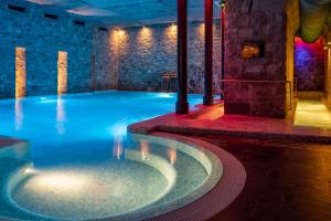 a large swimming pool in a building with a swimming pool at Hotel Helvetia Thermal Spa in Porretta Terme