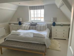 a bedroom with a large bed and a window at A Unique Cottage in the centre of Cley in Cley next the Sea