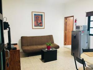 a living room with a couch and a refrigerator at Department, Studio Type Excellent Location in Mexico City
