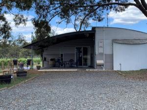 a large metal building with a garage at The Shedhouse at Milbrodale Farm in Bulga