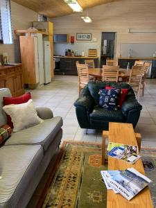 a living room with a couch and a table at The Shedhouse at Milbrodale Farm in Bulga