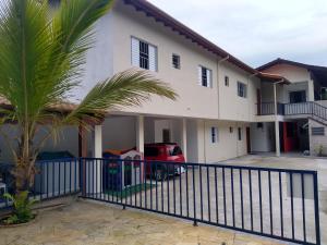 a house with a fence and a palm tree at Chalés Bielle de Ubatuba in Ubatuba +80 photos