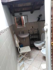 bagno con lavandino, servizi igienici e specchio di Dimora Giosafatti ad Ascoli Piceno
