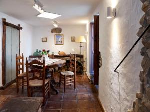 a dining room with a table and chairs at Mesón La Hospedería in Cómpeta