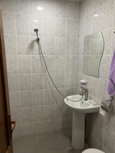 a bathroom with a sink and a mirror at Touristic House KAEL in Musalerr