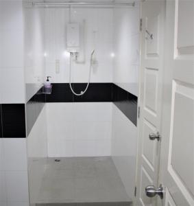 a white bathroom with a shower with a glass door at Mansion One SeaView Georgetown 2BR 6 Pax in George Town