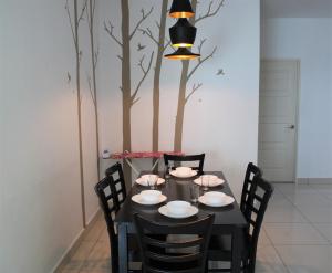 a black table with chairs and a tree mural at Mansion One SeaView Georgetown 2BR 6 Pax in George Town