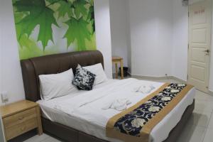 a bedroom with a large bed with a wooden night stand at Mansion One SeaView Georgetown 2BR 6 Pax in George Town
