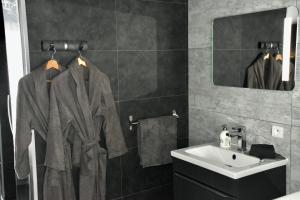 a bathroom with a sink and a mirror at Luxury & Love - Professional Jaccuzzi and Spa in Chelles