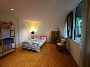 a bedroom with a bed and a wooden floor at Glashus-Moos Loft 2 in Moos