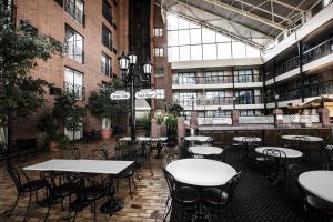 a room with tables and chairs in a building at Clifton Victoria Inn at the Falls in Niagara Falls