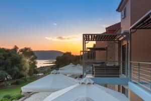 a view of a building with umbrellas on a balcony at Dialiskari Villas in Marathopoli