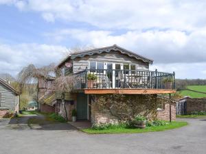 a house with a balcony on top of it at Bugatti House in Bosbury