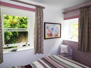 a bedroom with a bed and a window at T Melindwr in Capel Bangor