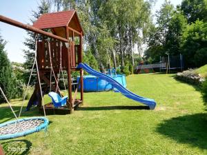 a playground with a slide and a swing at Chalupa Hořice na Šumavě in Hořice na Šumavě