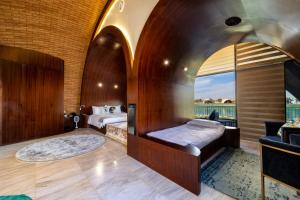 a hotel room with a bed and a window at Nirvana Retreat in Ras al Khaimah