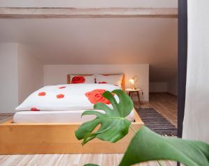 a bedroom with a bed with red flowers on it at Dolomitenloft in Strassen