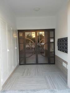 an empty room with a glass door in a building at Centro storico, nuovo con terrazzo in Lido di Ostia